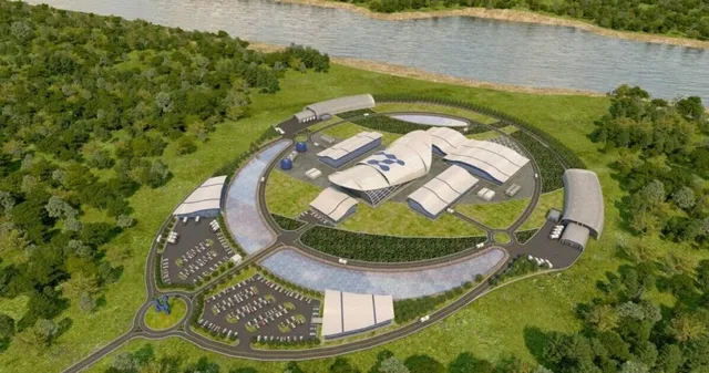 O reprezentare grafică de tip randare arată un complex de clădiri albe cu acoperișuri curbate, înconjurat de drumuri, parcări și vegetație lângă un râu.