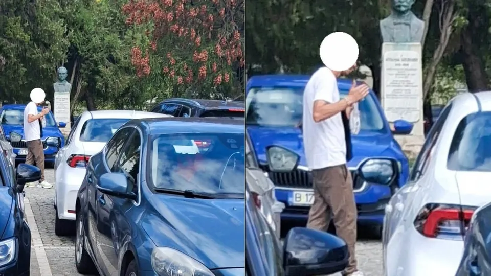 Un bărbat cu tricou alb și pantaloni maro stă lângă mașini parcate într-o zonă cu copaci și un bust pe un soclu.