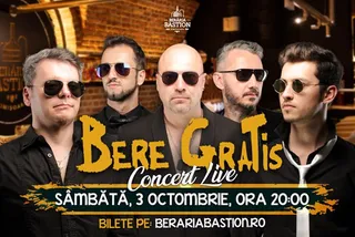Cinci bărbați poartă haine negre și ochelari de soare, fiind așezați în grup în fața unui fundal de cărămidă.