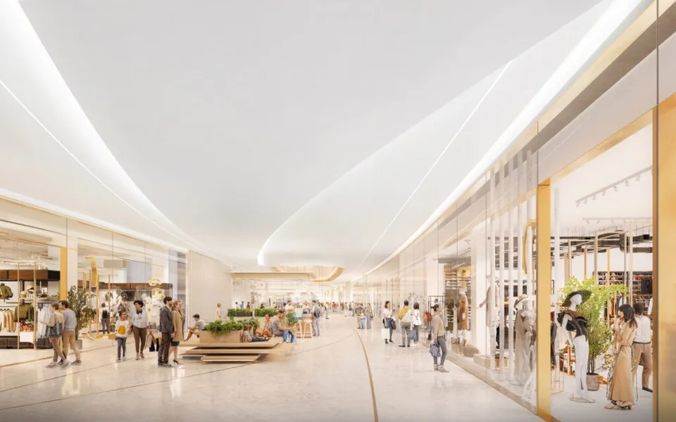O reprezentare digitală a unui coridor de mall cu vitrine de magazine, tavan alb curbat și persoane care merg pe un podea lucioasă.