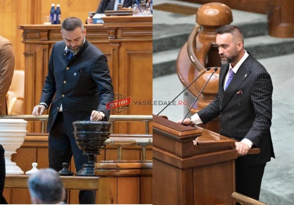 Un bărbat cu barbă, îmbrăcat în costum închis la culoare, stă în picioare lângă un pupitru de lemn într-o încăpere cu mobilier din lemn.