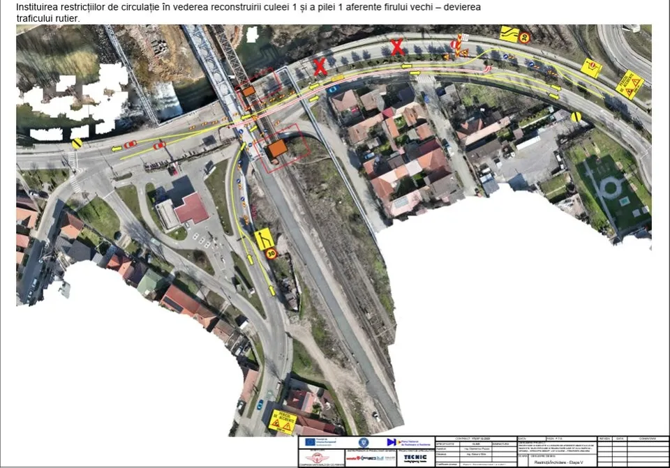 O hartă aeriană a unei zone urbane cu căi ferovare, linii galbene și marcaje roșii indicând trasee și restricții de circulație pe drumurile asfaltate.