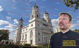 Un bărbat cu ochelari și barbă stă în prim-plan, în partea dreaptă, în fața unei catedrale albe cu turnuri rotunde sub un cer înnorat.