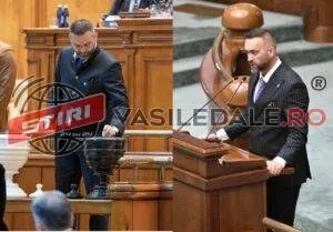 Un bărbat cu barbă, îmbrăcat în costum închis, stă în picioare lângă un pupitru de lemn într-o încăpere cu mobilier din lemn.