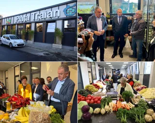 Un grup de bărbați stă în interiorul unei clădiri lângă mese cu diverse fructe și legume proaspete.