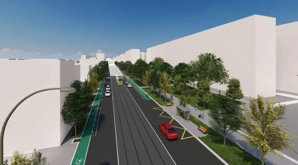 Reprezentare digitală a unei artere stradale cu mașini, piste de biciclete verzi, linii de tramvai, trotuare și copaci între clădiri albe.