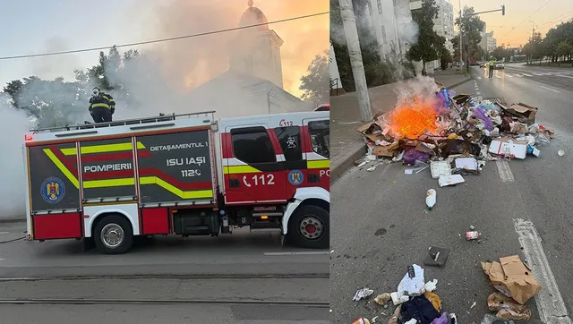 Un camion de pompieri este parcat pe o stradă lângă un morman de deșeuri care arde, producând flăcări și fum.