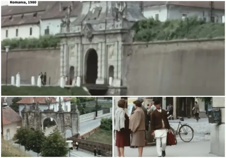 O poartă de piatră cu un arc central se află lângă un zid, în timp ce persoane merg pe un trotuar lângă o bicicletă.