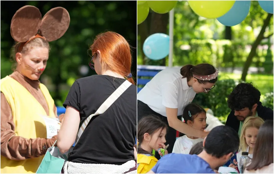 O femeie costumată și o femeie cu părul roșcat stau în parc, în timp ce în partea dreaptă un grup de adulți și copii stau la o masă.