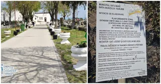 Un drum pavat trece printr-un cimitir cu morminte, ghivece albe și un panou informativ pe un fundal de vegetație.
