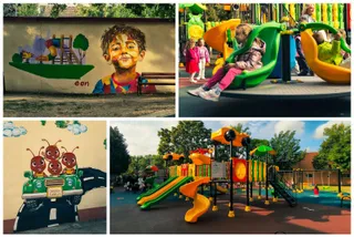 Un spațiu de joacă colorat cu tobogane și alte echipamente este situat pe un teren cu pardoseală moale, înconjurat de copaci și vegetație.