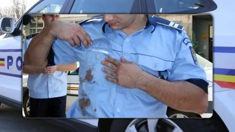 Un bărbat în uniformă albastră de polițist își verifică cămașa pe care se observă niște pete maronii.