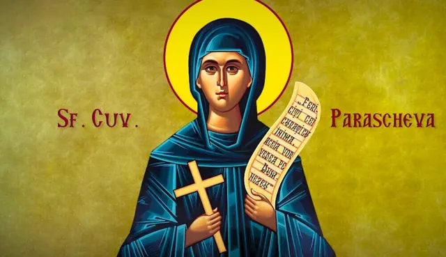O pictură religioasă reprezintă o femeie cu mantie albastră, purtând o aură galbenă în jurul capului, o cruce de lemn și un pergament scris.