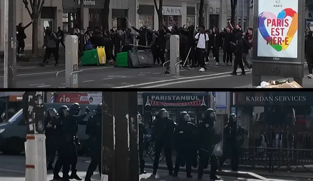 Un grup de persoane stă pe un drum urban lângă containere de deșeuri, în timp ce figuri în uniformă întunecată stau pe trotuar.
