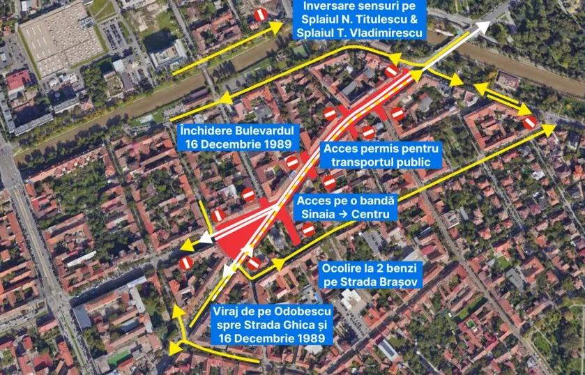 O vedere aeriană a unei zone urbane cu linii galbene, săgeți și etichete albastre pe fundalul unor clădiri și drumuri.