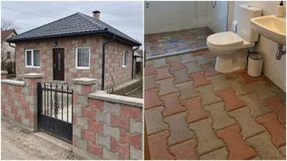 O casă cu zid de gard din blocuri colorate este prezentată lângă o baie cu podea pavată cu pavi de dimensiuni mici.