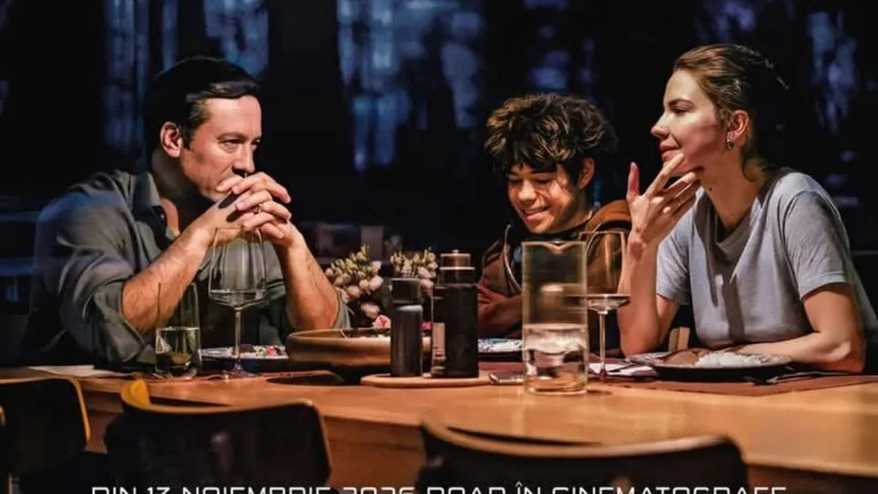 Three people are sitting at a dining table with glasses, a thermos, and plates, engaged in conversation.