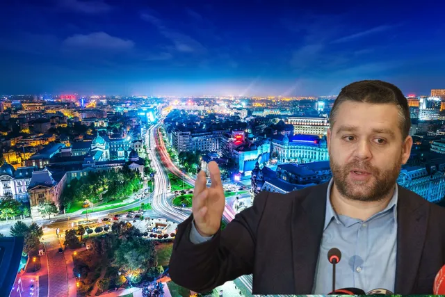 Un bărbat cu barbă, purtând sacou și cămașă, stă în prim-plan în fața unei panorame nocturne a unui oraș iluminat.