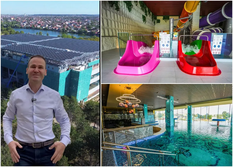 Un bărbat în cămașă albă stă în fața unei clădiri cu panouri solare, lângă două tobogane colorate și o piscină interioară cu apă albastră.