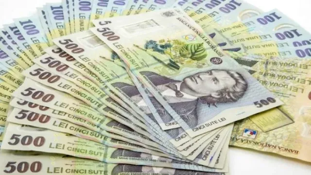 Mai multe bancnote de 500 de lei românești sunt întinse pe o suprafață albă.