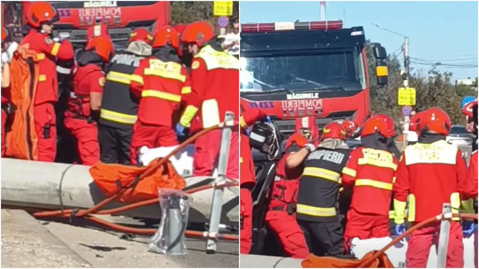 Mai mulți salvatori în uniforme roșii și galbene lucrează lângă un camion de pompieri și un obiect lung, cilindric, pe o stradă.