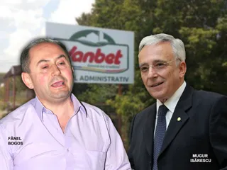 Un bărbat cu cămașă roz și un bărbat cu ochelari și costum întunecat stau unul lângă celălalt în fața unui panou publicitar.
