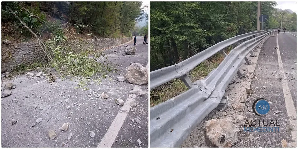 O porțiune de drum asfaltat este acoperită de pietre, resturi vegetale și un parapet metalic de pe marginea drumului.