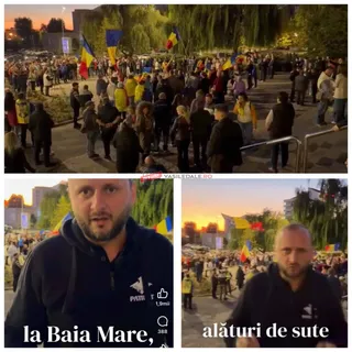 Un grup de persoane stă adunat pe o esplanadă în fața unor copaci, ridicând diverse steaguri colorate sub un cer de seară.
