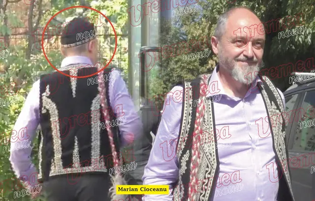 Un bărbat cu barbă și vestă tradițională neagră stă în picioare lângă un alt bărbat care poartă vestă tradițională și este văzut din spate.