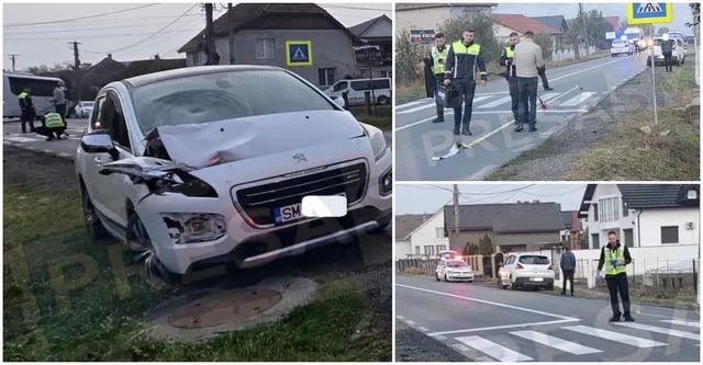 Un autoturism alb cu partea frontală zdrobită este oprit pe marginea unui drum lângă un pieton de culoare închisă și vegetație.
