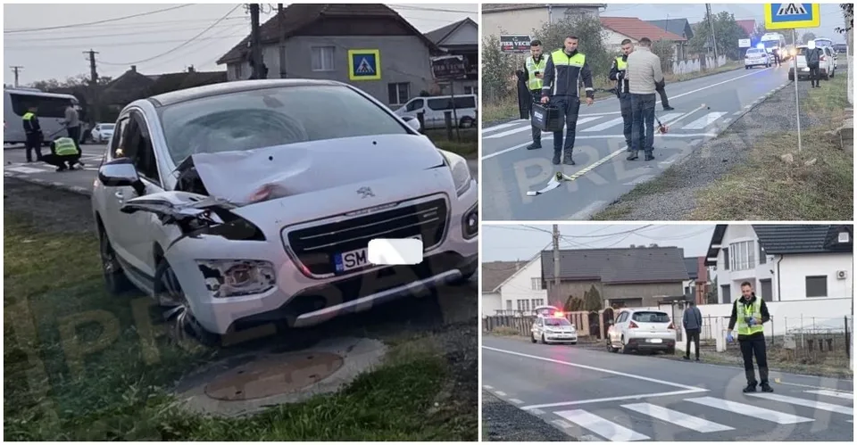 Un autoturism alb cu partea frontală zdrobită este oprit pe marginea unui drum lângă un pieton de culoare închisă și vegetație.