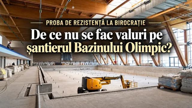 O mașină utilitară galbenă este poziționată într-un spațiu interior mare, cu structură de lemn și un podea de beton de dimensiuni considerabile.