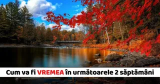 O ramură cu frunze roșii de arțar în prim-plan deasupra unui lac calm, cu pădure și un pod mic în fundal sub un cer înnorat.