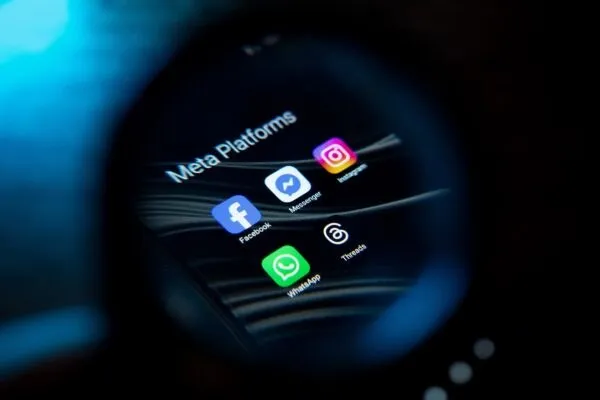 Logo-urile aplicațiilor Facebook, Messenger, Instagram, WhatsApp și Threads sunt afișate pe un ecran întunecat sub textul Meta Platforms.