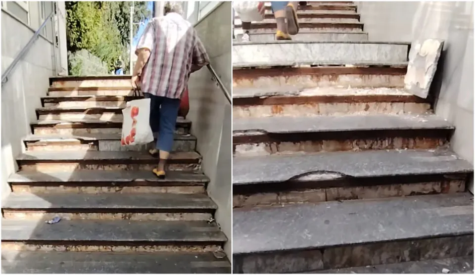 O persoană cu un sac de cumpărături coboară o scară de beton deteriorată, unde treptele prezintă suprafețe lipsă și fragmente de material desprins.