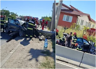 Un vehicul negru este situat lângă un stâlp doborât pe o zonă de marginea drumului, în prezența unor persoane îmbrăcate în uniforme de pompieri.