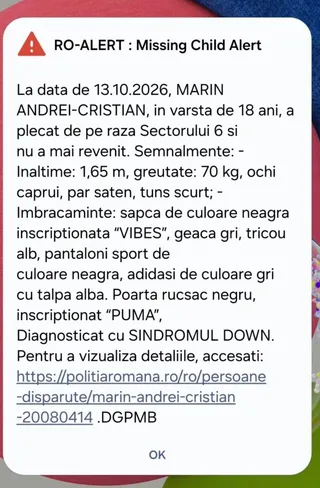 Un mesaj de alertă pe un ecran afișează detalii textuale despre o persoană dispărută, inclusiv nume, date, trăsături fizice și descrierea îmbrăcămintei.