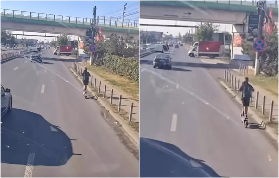 O persoană pe o trotinetă electrică circulă pe o bandă de circulație lângă un gard de stâlpi mici, sub un pod de beton.