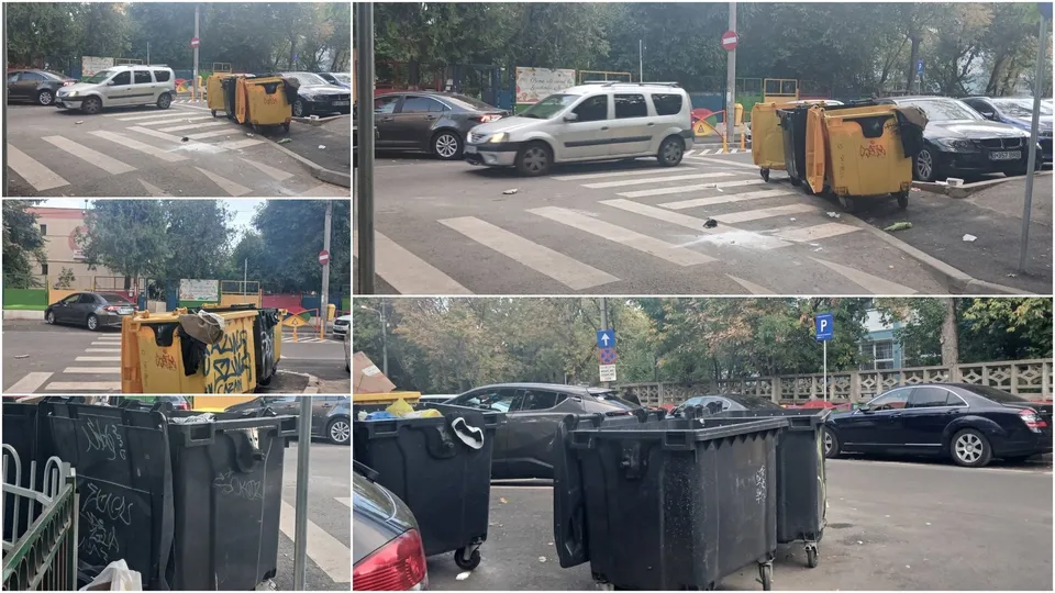 Containere de gunoi de culoare galbenă și neagră sunt amplasate pe un zebru de pe o stradă cu mașini parcate în fundal.