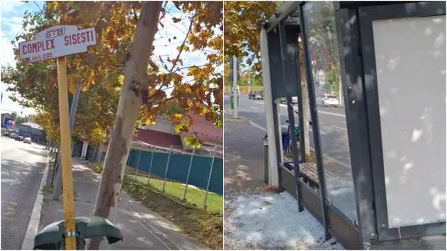 O stație de autobuz cu panouri de sticlă spartă și o placă de identificare pe un stâlp galben sunt situate lângă un drum.